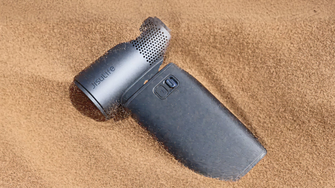 Jisulife labeled fan partially buried in sand